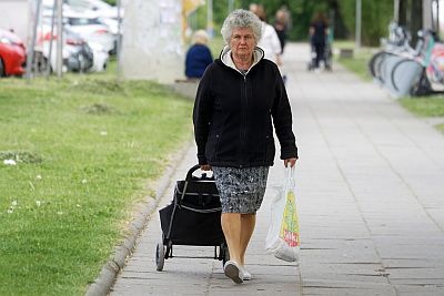 Elderly woman with a shopping trolley